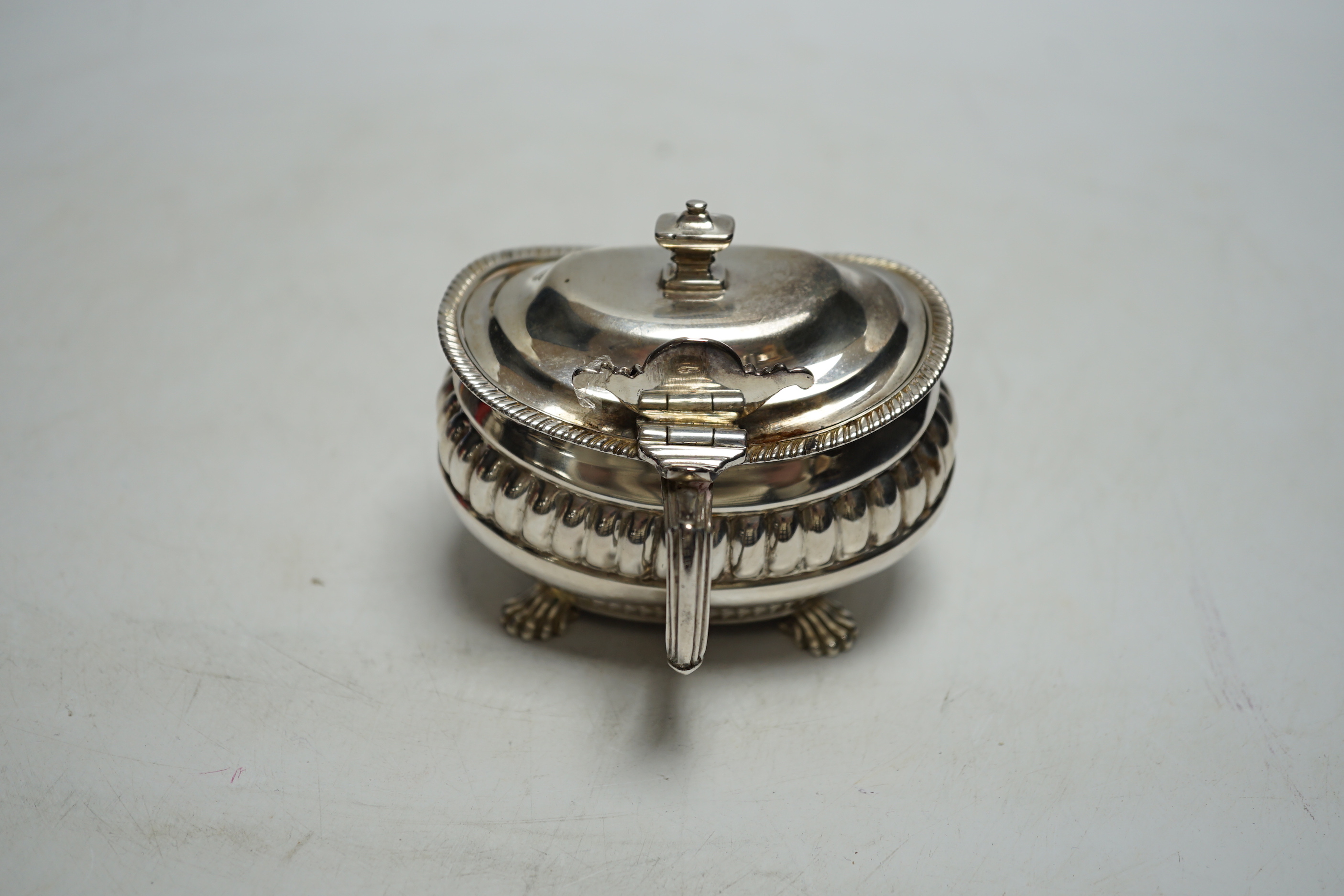 A George III demi fluted silver lidded mustard pot, London 1811 by Alexander Hewat?, length 9cm.